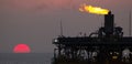 Oil platform and flare at sunset Royalty Free Stock Photo