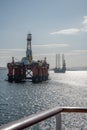 Oil Platform and offshore wind turbine installation ship in the bay of Invergordon, Scotland, vertical shot, fence of a cruise Royalty Free Stock Photo