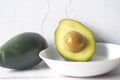 oil pouring on slice of avocado on wooden table