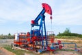 The oil pump, industrial equipment. Oil field site, oil pumps are running. Rocking machines for oil production in a Royalty Free Stock Photo