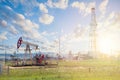 Oil pump jack. Pumpjack against sky clouds Royalty Free Stock Photo