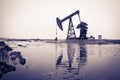 Oil pump jack and reflection Royalty Free Stock Photo