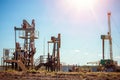 Oil pump jack rocking with pipeline in the background. Rocking machines for power generation. Extraction of oil. Royalty Free Stock Photo