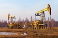 Oil pump jack rocking with pipeline in the background. Rocking machines for power generation. Extraction of oil Royalty Free Stock Photo