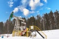 Oil pump jack winter working. At the sky with clouds. Oil rig energy industrial machine for petroleum in the sunset background for Royalty Free Stock Photo