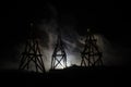 Oil pump oil rig energy industrial machine for petroleum, Group oil rigs and brightly lit industrial site at night. Toned.Backgrou