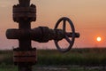 Oil pump valve at sunset Royalty Free Stock Photo