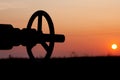 Oil pump valve at sunset Royalty Free Stock Photo