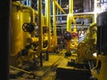 Oil pump, yellow pipes, tubes, machinery at power plant