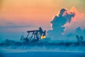 The oil pumping units sunrise in winter in Daqing oil fields Royalty Free Stock Photo