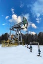 Oil pumpjack winter work is the overground drive for a reciprocating piston pump in an oil well. It is used to mechanically lift Royalty Free Stock Photo