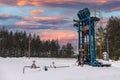 Oil pumpjack winter working. Oil rig energy industrial machine for petroleum in the sunset background for design. Oil pressure Royalty Free Stock Photo
