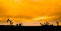 Oil pumps at oil field with sunset sky background Royalty Free Stock Photo