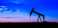 Oil pumps at oil field with sunset sky background