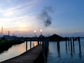 Oil refinery bursting flames at sunset, Venice Italy Royalty Free Stock Photo