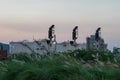 Oil Refinery factory in evening with grass for foreground, Petr