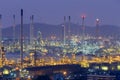 Oil refinery lights night view with mountain Royalty Free Stock Photo