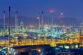 Oil refinery lights night view with mountain background Royalty Free Stock Photo