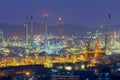 Oil refinery night lights with mountain Royalty Free Stock Photo