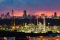 Oil refinery night view with city downtown