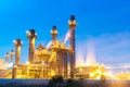 Oil refinery, petroleum and energy plant at twilight with sky background.