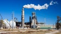 Oil refinery plant with chimney blowing smoke Royalty Free Stock Photo