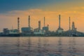 Oil refinery reflected on river during sunrise time Royalty Free Stock Photo