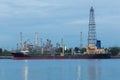 Oil refinery river side with boat tank