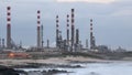 Oil refinery by the sea at dawn Royalty Free Stock Photo