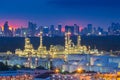 Oil refinery at twilight with city background