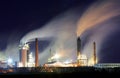 Oil refinery with vapor - petrochemical industry at night