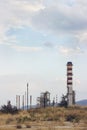 Oil refinery with visible smoke coming out of chimneys; pollution concept, with copy space