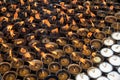 Oil religious candles glowing with orange flames on a hindu temple. Symbols of faith and religion and for wishes and