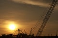 Oil rig crane on sunset