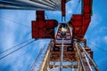 Oil rig derrick in oilfield against the bright blue sky. Drilling rig in oil field for drilled into subsurface in order