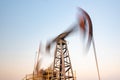 Oil rig silhouette working at sunset. Blur at slow shutter speeds Royalty Free Stock Photo