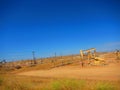 Oil rigs/oil drilling equipment in a field in a california valley