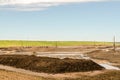 Oil sands refinery industry landscape, brown ground and blue sky