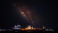 Oil ship tanker on the sea at night over lightings with beautiful starlight background waiting for load/unload crude oil from iol