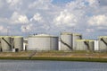 Oil silos along a canal Royalty Free Stock Photo