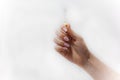 Oil, essence, natural extract in a glass test tube in a female hand