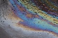 Oil slick on the asphalt road background. Stylish background image.