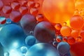 Oil spheres in the water, close-up macro shot in front of a multi-colored background. Royalty Free Stock Photo