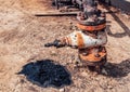 Oil spill and valve Royalty Free Stock Photo