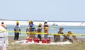 Oil spill workers at seashore Royalty Free Stock Photo