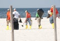 Oil spill workers at seashore Royalty Free Stock Photo