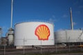 Oil storage tank at the Shell refinery with logo big on it at the Pernis harbor in the port of Rotterdam. Royalty Free Stock Photo