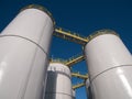 Oil storage tanks / silos against a clear blue sky