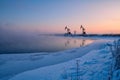 The  oil sucking machine in lakeside sunrise, Daqing oil fields Heilongjiang province, China. Royalty Free Stock Photo