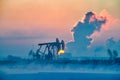 The oil sucking machine lakeside sunrise in winter in Daqing oil fields Royalty Free Stock Photo